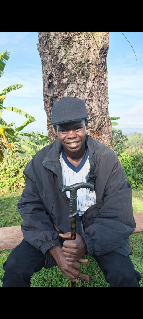 Man with a cane sitting outdoors